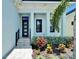 Beautifully landscaped front entrance with a modern door, complemented by lush greenery at 6530 Simone Shores Cir, Apollo Beach, FL 33572