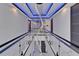 Hallway with sleek glass railings, modern lighting, and elegant design at 6530 Simone Shores Cir, Apollo Beach, FL 33572