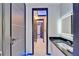 Modern hallway with tiled flooring, ambient lighting, and streamlined design at 6530 Simone Shores Cir, Apollo Beach, FL 33572