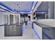 A modern kitchen featuring an island, stainless steel appliances and glossy cabinets and countertops with LED lighting at 6530 Simone Shores Cir, Apollo Beach, FL 33572