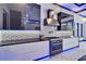 Modern kitchen features stainless steel appliances, black countertops and an integrated exhaust hood above the stovetop at 6530 Simone Shores Cir, Apollo Beach, FL 33572