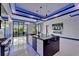 Modern kitchen features an island, stainless steel appliances, glossy cabinets and countertops with LED lighting at 6530 Simone Shores Cir, Apollo Beach, FL 33572