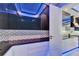 Modern kitchen with stainless steel appliances, sleek black cabinets and countertops with LED lighting at 6530 Simone Shores Cir, Apollo Beach, FL 33572