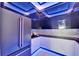 Modern kitchen with stainless steel appliances, sleek black cabinets, countertops and LED lighting at 6530 Simone Shores Cir, Apollo Beach, FL 33572