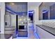 Modern kitchen with stainless steel appliances, sleek black cabinets and countertops and LED lighting at 6530 Simone Shores Cir, Apollo Beach, FL 33572