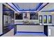 This is a modern kitchen featuring an island, stainless steel appliances and glossy cabinets and countertops with LED lighting at 6530 Simone Shores Cir, Apollo Beach, FL 33572