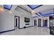 Open-concept living area with marble floors, modern fireplace, and access to kitchen at 6530 Simone Shores Cir, Apollo Beach, FL 33572