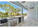 A covered patio features an outdoor kitchen with a gas grill, sink, and beverage cooler at 6530 Simone Shores Cir, Apollo Beach, FL 33572