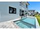 Modern home featuring a swimming pool and spa, perfect for outdoor entertainment and relaxation at 6530 Simone Shores Cir, Apollo Beach, FL 33572