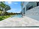 Enjoy this backyard pool with a stone patio and lush lawn, perfect for relaxation and entertainment at 6530 Simone Shores Cir, Apollo Beach, FL 33572