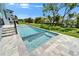 Beautiful outdoor pool and spa with pavers and a lush green lawn with canal views at 6530 Simone Shores Cir, Apollo Beach, FL 33572