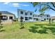 Well-manicured lawn complements the home's rear exterior, enhancing its curb appeal and outdoor living space at 6530 Simone Shores Cir, Apollo Beach, FL 33572