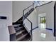 View of a modern staircase with glass railings and sleek design, bathed in natural light at 6530 Simone Shores Cir, Apollo Beach, FL 33572