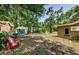 A lush backyard featuring mature trees, a storage shed, and inviting outdoor seating at 6618 N 11Th St, Tampa, FL 33604