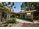 Charming backyard featuring a garden and blue door, perfect for outdoor relaxation and entertaining at 6618 N 11Th St, Tampa, FL 33604