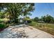 Street view of the home showing the long driveway and simple landscaping at 6618 N 11Th St, Tampa, FL 33604