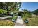 Charming home featuring a welcoming front yard with mature landscaping and a paved walkway at 6618 N 11Th St, Tampa, FL 33604