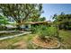 Charming home with mature landscaping in the front yard and a quaint stone-lined garden bed at 6618 N 11Th St, Tampa, FL 33604