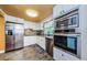 Bright kitchen featuring white cabinets, stainless steel appliances, and a large window at 6618 N 11Th St, Tampa, FL 33604