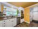 Charming kitchen with white cabinets, stainless steel appliances, and lots of natural light at 6618 N 11Th St, Tampa, FL 33604