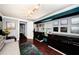 This living room includes dark wood floors, a gray couch, and multiple pieces of artwork at 6618 N 11Th St, Tampa, FL 33604