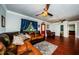 Well-lit living room with a leather sofa, wood floors, and attractive interior design elements at 6618 N 11Th St, Tampa, FL 33604