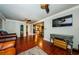 Open living room with sleek wood floors, comfortable seating, and a view into the kitchen at 6618 N 11Th St, Tampa, FL 33604