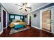 A well-appointed primary bedroom featuring hardwood flooring, fan, and an ensuite bathroom at 6618 N 11Th St, Tampa, FL 33604