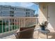 Relaxing balcony featuring comfortable seating and serene views of the fountain and lush surroundings at 6817 Stones Throw N Cir # 17203, St Petersburg, FL 33710