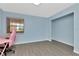This room features blue walls, and a window with light streaming in at 6817 Stones Throw N Cir # 17203, St Petersburg, FL 33710