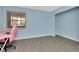 Bedroom featuring wood-look flooring, a window, and space for a desk at 6817 Stones Throw N Cir # 17203, St Petersburg, FL 33710