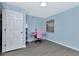 This room features blue walls, and a window with light streaming in at 6817 Stones Throw N Cir # 17203, St Petersburg, FL 33710