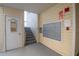 Condo building hallway entrance with stairs, storage closet, and mailboxes for convenient resident access at 6817 Stones Throw N Cir # 17203, St Petersburg, FL 33710