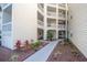 Inviting condo building exterior with landscaped walkway and multiple floors with private balconies at 6817 Stones Throw N Cir # 17203, St Petersburg, FL 33710
