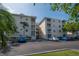 Complex exterior view with balconies, parking, and well-maintained landscaping at 6817 Stones Throw N Cir # 17203, St Petersburg, FL 33710