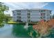 Gorgeous condo building featuring waterfront views, multiple private balconies, and a lovely water fountain at 6817 Stones Throw N Cir # 17203, St Petersburg, FL 33710