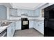 Well-lit kitchen boasts ample cabinetry, modern appliances, and durable countertops at 6817 Stones Throw N Cir # 17203, St Petersburg, FL 33710