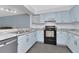 Bright kitchen with updated countertops, blue cabinets and black appliances at 6817 Stones Throw N Cir # 17203, St Petersburg, FL 33710