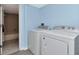 Laundry area with new washer and dryer units, adjacent to bathroom at 6817 Stones Throw N Cir # 17203, St Petersburg, FL 33710