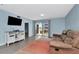 Inviting living room with a plush sofa, TV, and a sliding glass door to the balcony at 6817 Stones Throw N Cir # 17203, St Petersburg, FL 33710
