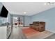Inviting living room with a plush sofa, TV, and a sliding glass door to the balcony at 6817 Stones Throw N Cir # 17203, St Petersburg, FL 33710