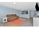 Living room with a view to the kitchen, a sofa and entertainment center at 6817 Stones Throw N Cir # 17203, St Petersburg, FL 33710