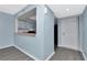 Living room with stylish gray wood floors leading to kitchen with breakfast bar at 6817 Stones Throw N Cir # 17203, St Petersburg, FL 33710