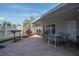Relaxing outdoor patio area with dining table and chairs and a nearby grill at 6817 Stones Throw N Cir # 17203, St Petersburg, FL 33710