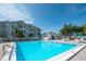 View of the community pool showing cool, inviting waters and surrounding buildings at 6817 Stones Throw N Cir # 17203, St Petersburg, FL 33710