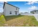 Spacious backyard with a well-maintained lawn and a sturdy white fence for privacy at 71 Rose Bud Ln, Spring Hill, FL 34609