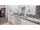Bathroom featuring double vanity with granite countertops and large mirror at 71 Rose Bud Ln, Spring Hill, FL 34609