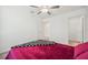 A bright bedroom with white walls, a ceiling fan, and carpet flooring at 71 Rose Bud Ln, Spring Hill, FL 34609