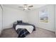 Bedroom with a window, carpeted floors, and a striped comforter at 71 Rose Bud Ln, Spring Hill, FL 34609