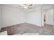 Spacious bedroom with a ceiling fan, double door closet, and carpet flooring at 71 Rose Bud Ln, Spring Hill, FL 34609